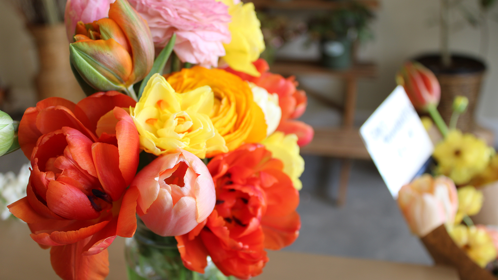 Red and yellow cut flowers in a vase.