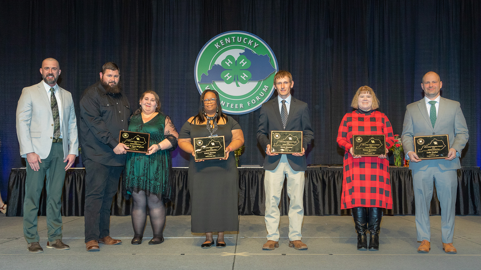 volunteers on a stage earning their awards for volunteering with Kentucky 4-H.