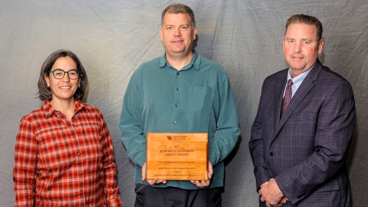 Jamie Matthews presented the Research Extension Impact Award to Erin Haramoto and Jason Unrine, sharing the award with Brad Lee and John Grove (not pictured). Provided by Martin-Gatton CAFE