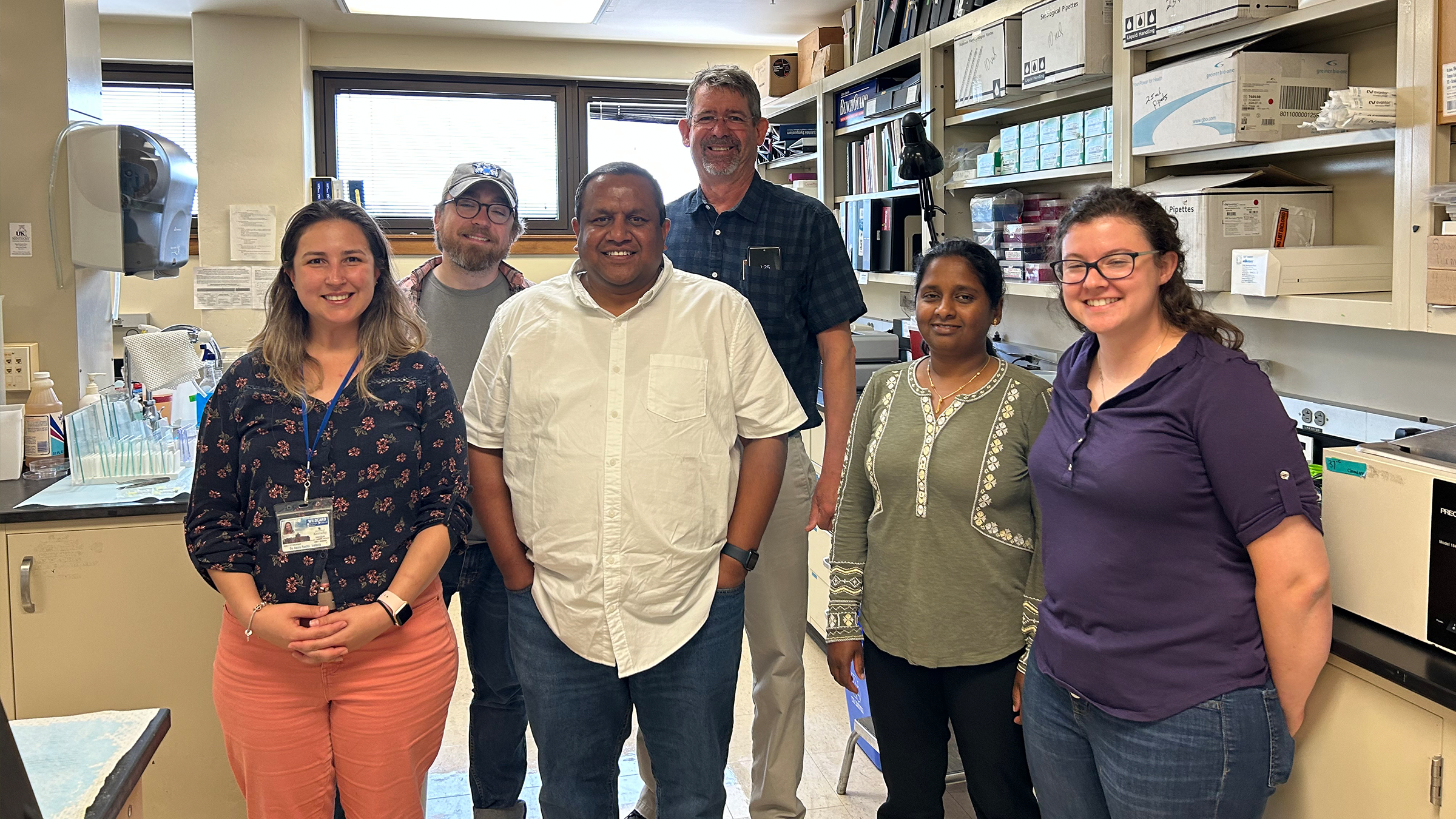 Several people pose for a photo in a research lab.