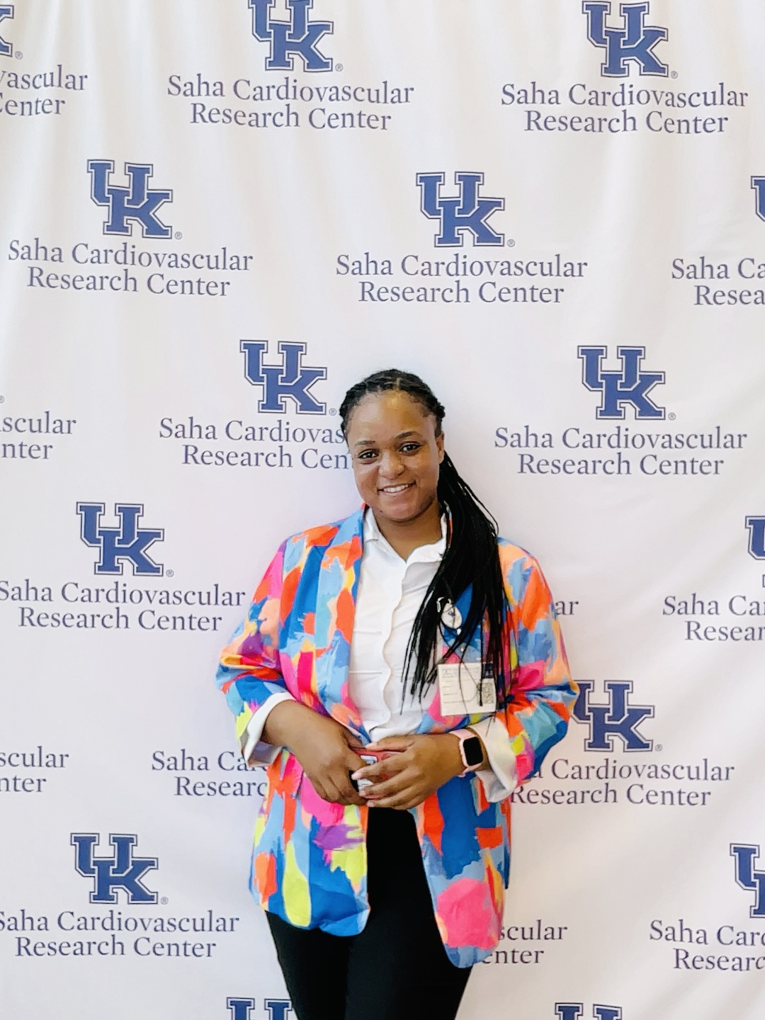 A woman poses in front of a UK backdrop.